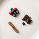 Chocolate, berries and cinnamon illustrating KICKSTART coffee tasting notes.