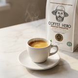 Espresso with golden crema in a white cup beside a Coffee Hero Smooth Operator bag.